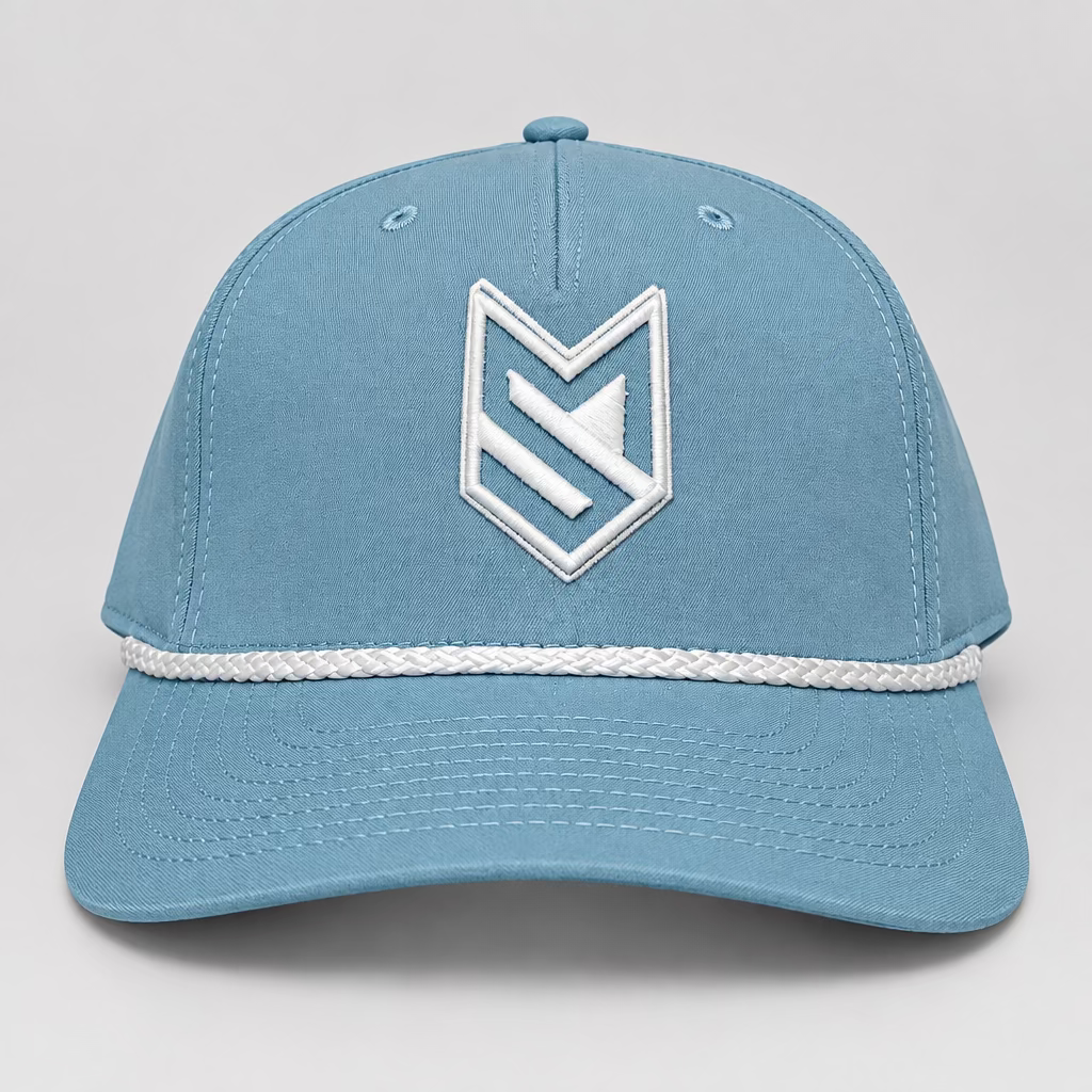 A light blue baseball cap with a white embroidered geometric logo on the front and a white braided stripe detail across the brim, displayed on a white surface with a white paneled door in the background.