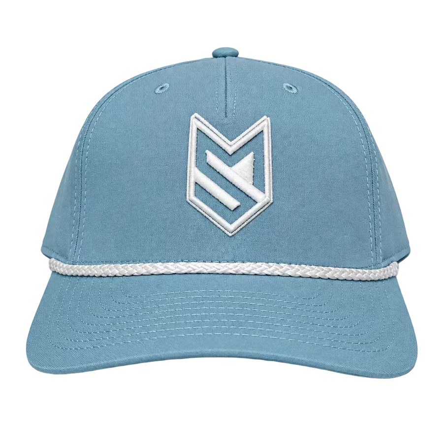 A light blue baseball cap with a white embroidered geometric logo on the front and a white braided stripe detail across the brim, displayed on a white surface with a white paneled door in the background.