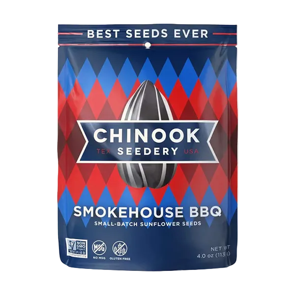 A package of Chinook Sunflower Seeds branded as Smokehouse BBQ flavor. The packaging is predominantly red and blue with an image of a sunflower seed in the center and the text 'Best Seeds Ever' at the top.